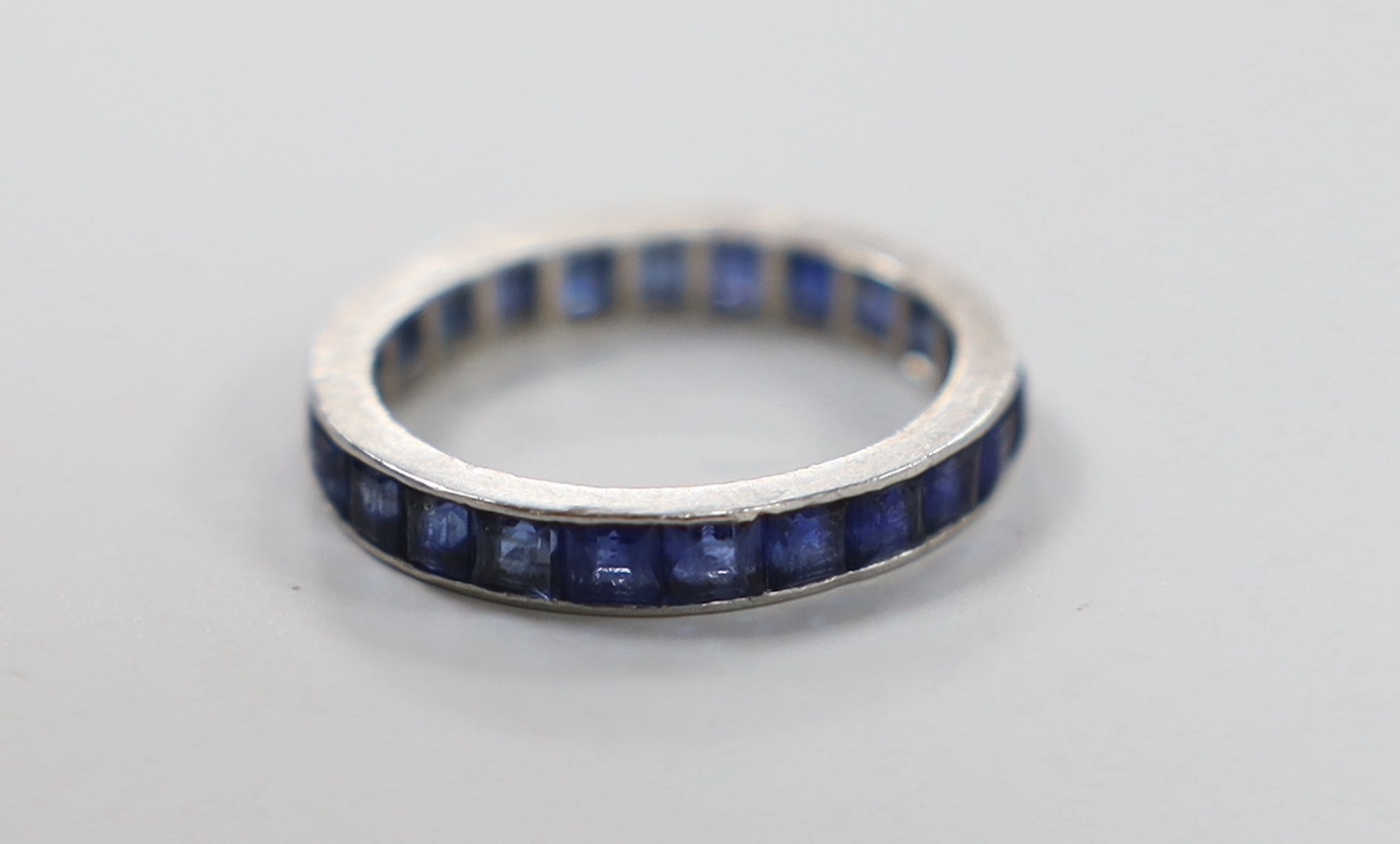 A white metal and sapphire set full eternity ring, size K, gross weight 2.6 grams.